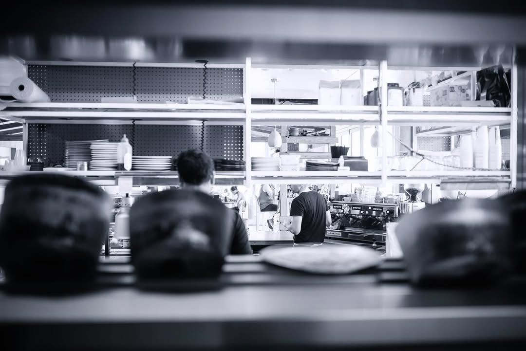 Kitchen pass during service, in black and white